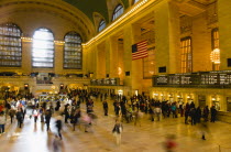 USA, New York, Manhattan, Grand Central Terminal railway station with people walking in the Main Concourse and passengers buying tickets.