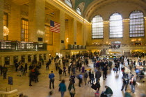 USA, New York, Manhattan, Grand Central Terminal railway station with people walking in the Main Concourse and passengers buying tickets.