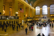 USA, New York, Manhattan, Grand Central Terminal railway station with people walking in the Main Concourse and passengers buying tickets.