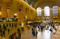 USA, New York, Manhattan, Grand Central Terminal railway station with people walking in the Main Concourse and passengers buying tickets.