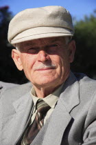 Albania, Tirane, Tirana, Head and shoulders, full face  portrait of an elderly man wearing a hat.