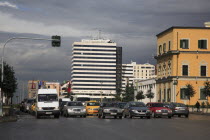 Albania, Tirane, Tirana. Traffic waiting at lights in Skanderbeg Square in front of the Tirana International Hotel.