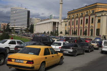 Albania, Tirane, Tirana. Congested traffic in front of the Opera House, Ethem Bey Mosque and government buildings on Skanderbeg Square.