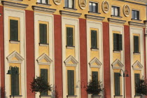 Albania, Tirane, Tirana, Detail of red and yellow exterior facade of government buildings on Skanderbeg Square.