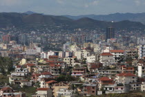 Albania, Tirane, Tirana, view across residential buildings to the hillside beyond.