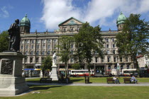 Ireland, North, Belfast, people sat in the city hall lawns enjoying the sunshine.