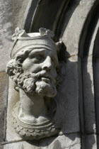 Ireland, Dublin, Crowned Bearded face carved in stone on building exterior.