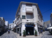 Portugal, Algarve, FAro, Main Shopping area with white washed buildings and colourfully decorated pavement.