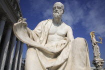 Austria, Vienna, Statue of Polybius, the Greek historian, in front of Parliament with statue of Athena in the background to the right.