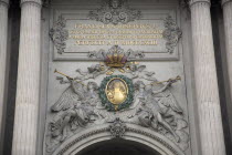 Austria, Vienna, Inscription & sculpted figures above the Michaelertrakt gateway to the Hofburg Palace