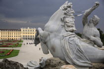 Austria, Vienna, Detail from the Neptune Fountain with the Schonnbrunn Palace in the background.