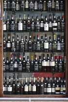 Portugal, Lisbon, Display of port bottles in a shop front window.