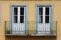 Portugal, Estremadura, Lisbon, Windows and balcony of a town house in the Barrio Alto district.