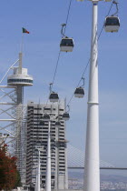 Portugal, Estremadura, Lisbon, Cable Cars  in the Park of Nations with the Vasco da Gama Tower in the background.