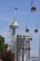 Portugal, Estremadura, Lisbon, Cable Cars  in the Park of Nations with the Vasco da Gama Tower in the background.