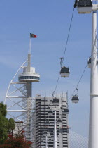 Portugal, Estremadura, Lisbon, Cable Cars  in the Park of Nations with the Vasco da Gama Tower in the background.