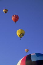 USA, New Mexico, Albuquerque, Annual balloon fiesta, Colourful hot air balloons ascending.