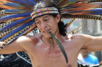 Mexico, Federal District, Mexico City, Michicoa Aztec dancer performing in the Zocalo.