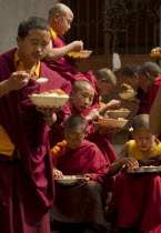 India, Sikkim, Buddhist Monks at lunch break.