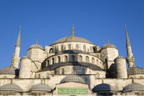 Turkey, Istanbul, Sultanahmet Camii, The Blue Mosque domes seen from the Courtyard with Arabic text from the Koran.