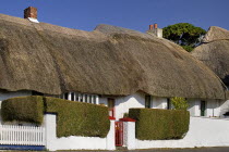 Ireland, County Waterford, Dunmore East, Traditional thatched cottage.