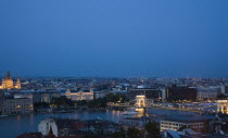 Hungary, Budapest, Buda Castle District, view over Danube and Pest with St Stephen's Basilica illuminated.