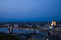 Hungary, Budapest, Buda Castle District, view over Danube and Pest with Parliament Building illuminated.