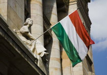 Hungary, Budapest, Hungarian Flag flying with Art Nouveau facade behind  in central Pest.