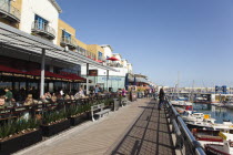 England, East Sussex, Brighton, View along the boardwalk over boats moored in the Marina.