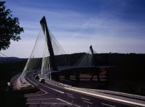 France, Bretagne, Finistere, Ile de Crozon. new pont de terenez suspension bridge view south from hillside above river aulne shows two lane carriageway and suspension supports.