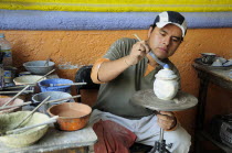 Mexico, Puebla, Talavera ceramic artist at Armando Gallery.