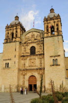 Mexico, Oaxaca, Church of Santo Domingo, exterior facade and bell towers with small group of people standing outside entrance.