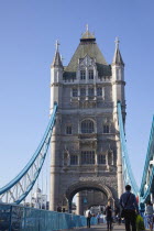 England, London, Tower Bridge with early morning commuters crossing.