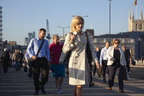 England, London, Early morning commuters crossing London Bridge towards the City Financial district.