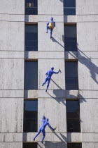 England, London, Borough High street building with sculptures called Blue Men, by Ofra Zimbalista, attached to facade.