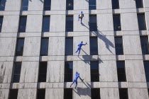 England, London, Borough High street building with sculptures called Blue Men, by Ofra Zimbalista, attached to facade.