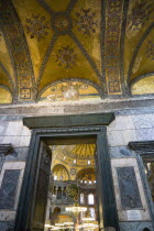 Turkey, Istanbul, Sultanahmet, Haghia Sophia The Imperial Gate with mosaics above and the Nave of the Cathedral beyond.