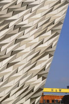 Ireland, Belfast, Titanic Quarter, Titanic Belfast Visitor Experience, Section of building with yellow Harland & Wolff crane.