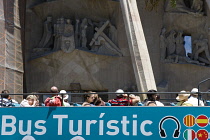 Spain, Catalonia, Barcelona, Tourists on a bus viewing the basilica church of Sagrada Familia deisigned by Antoni Gaudi in the Eixample district.