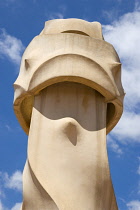 Spain, Catalonia, Barcelona, Chimneys and vents on the roof of Casa Mila apartment building known as La Pedrera or Stone Quarry designed by Antoni Gaudi in the Eixample district.