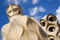 Spain, Catalonia, Barcelona, Chimneys and vents on the roof of Casa Mila apartment building known as La Pedrera or Stone Quarry designed by Antoni Gaudi in the Eixample district.