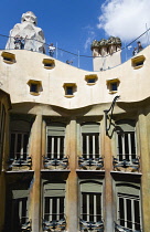 Spain, Catalonia, Barcelona,Tourist visitors on the roof of Casa Mila apartment building known as La Pedrera or Stone Quarry designed by Antoni Gaudi in the Eixample district.