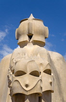 Spain, Catalonia, Barcelona, Chimneys and vents on the roof of Casa Mila apartment building known as La Pedrera or Stone Quarry designed by Antoni Gaudi in the Eixample district.