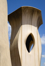 Spain, Catalonia, Barcelona, Chimneys and vents on the roof of Casa Mila apartment building known as La Pedrera or Stone Quarry designed by Antoni Gaudi in the Eixample district.