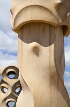 Spain, Catalonia, Barcelona, Chimneys and vents on the roof of Casa Mila apartment building known as La Pedrera or Stone Quarry designed by Antoni Gaudi in the Eixample district.