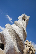 Spain, Catalonia, Barcelona, Chimneys and vents on the roof of Casa Mila apartment building known as La Pedrera or Stone Quarry designed by Antoni Gaudi in the Eixample district.