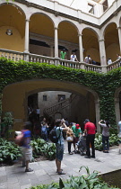 Spain, Catalonia, Barcelona, Tourists in the courtyard of the Crown of Aragon archive building.