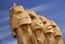 Spain, Catalunya, Barcelona, Antoni Gaudi's La Pedrera building, a section of chimney pots on the roof terrace.