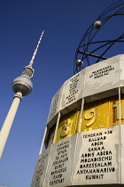 Germany, Berlin, Weltzeituhr also known as the World Clock in Alexanderplatz with the Fernsehturm Berlin's TV Tower in the background.
