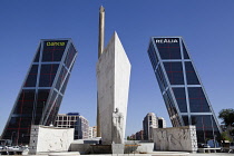 Spain, Madrid, Puerta de Europa with the monument to Calvo Sotelo in the foreground at Plaza de Castilla.